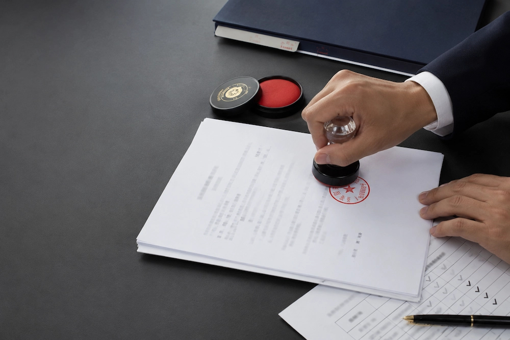 Company chop being applied to a corporate contract in China